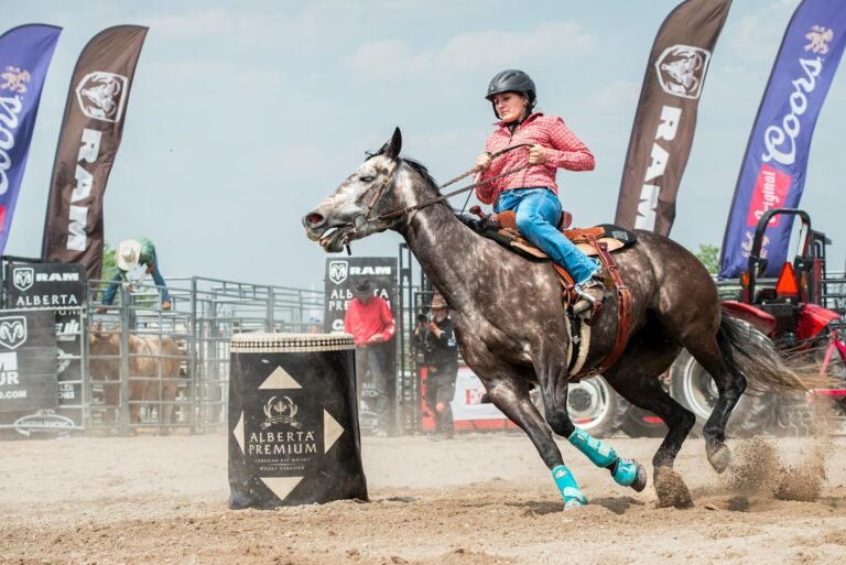 woman saddle bronc riding during rodeo event