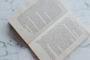 opened book lying on marble desktop