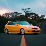 yellow car on the asphalt road