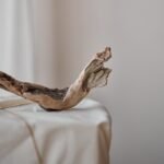 wooden driftwood on pedestal wrapped with fabric